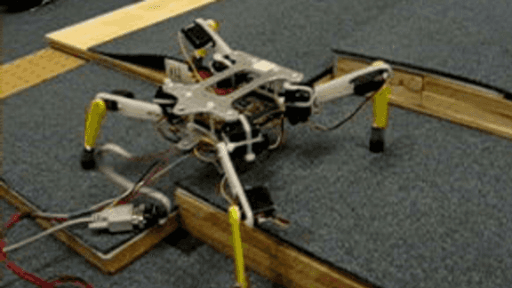 Quadruped Robot Obstacle Negotiation Via Reinforcement Learning